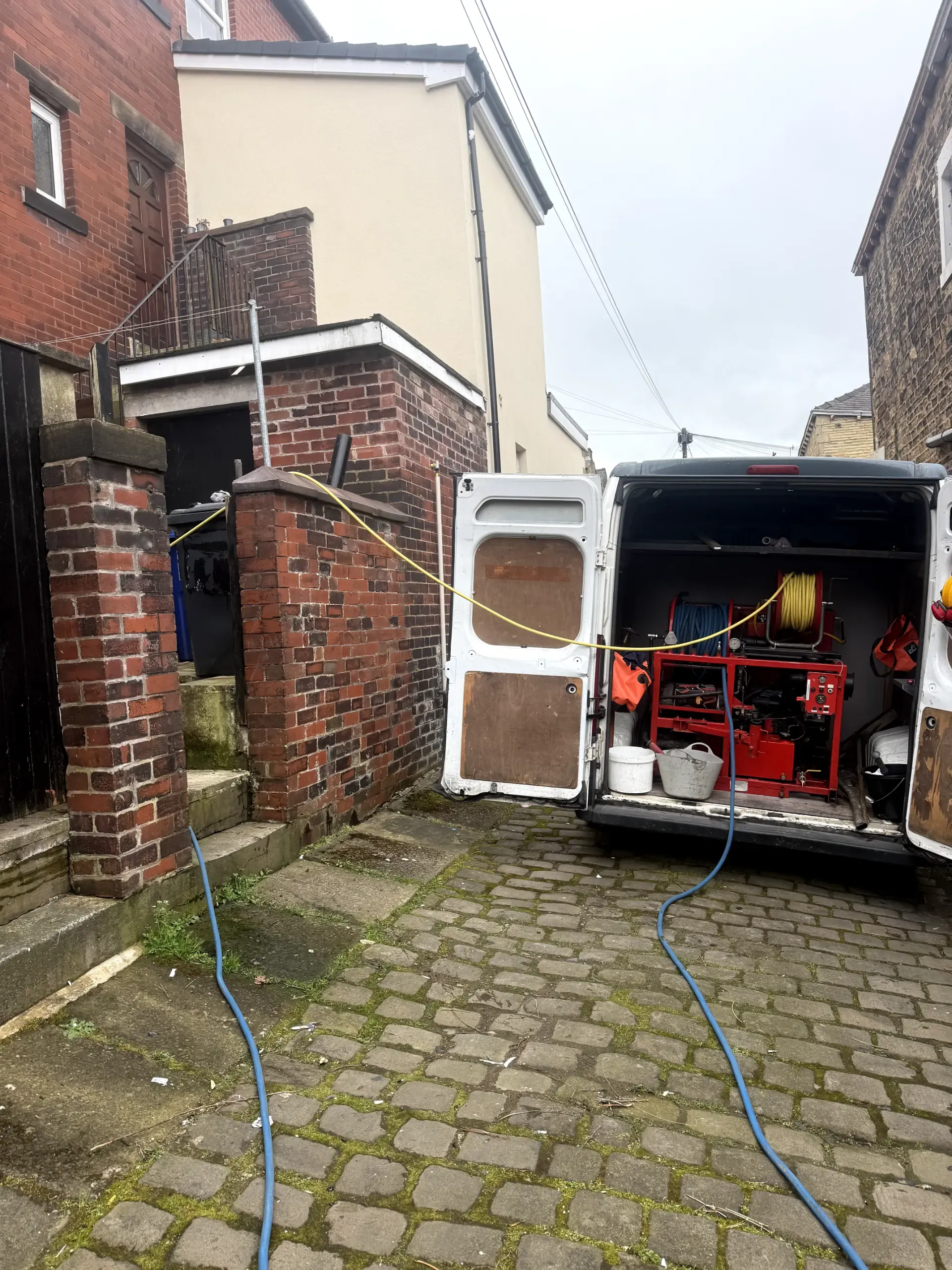 WGS Services van with high-pressure water jetting equipment unblocking a residential drain in Darwen.